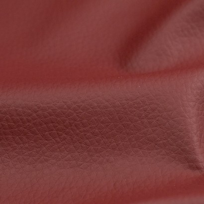 Tela de polipiel tapicería con textura detalle granate