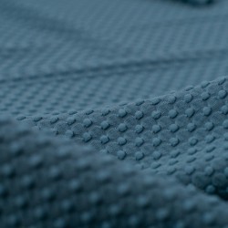 Tela de punto bodoques detalle azul turquesa